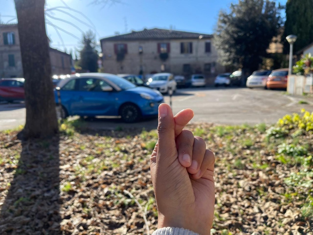Asmara's hand making a finger heart in Italy